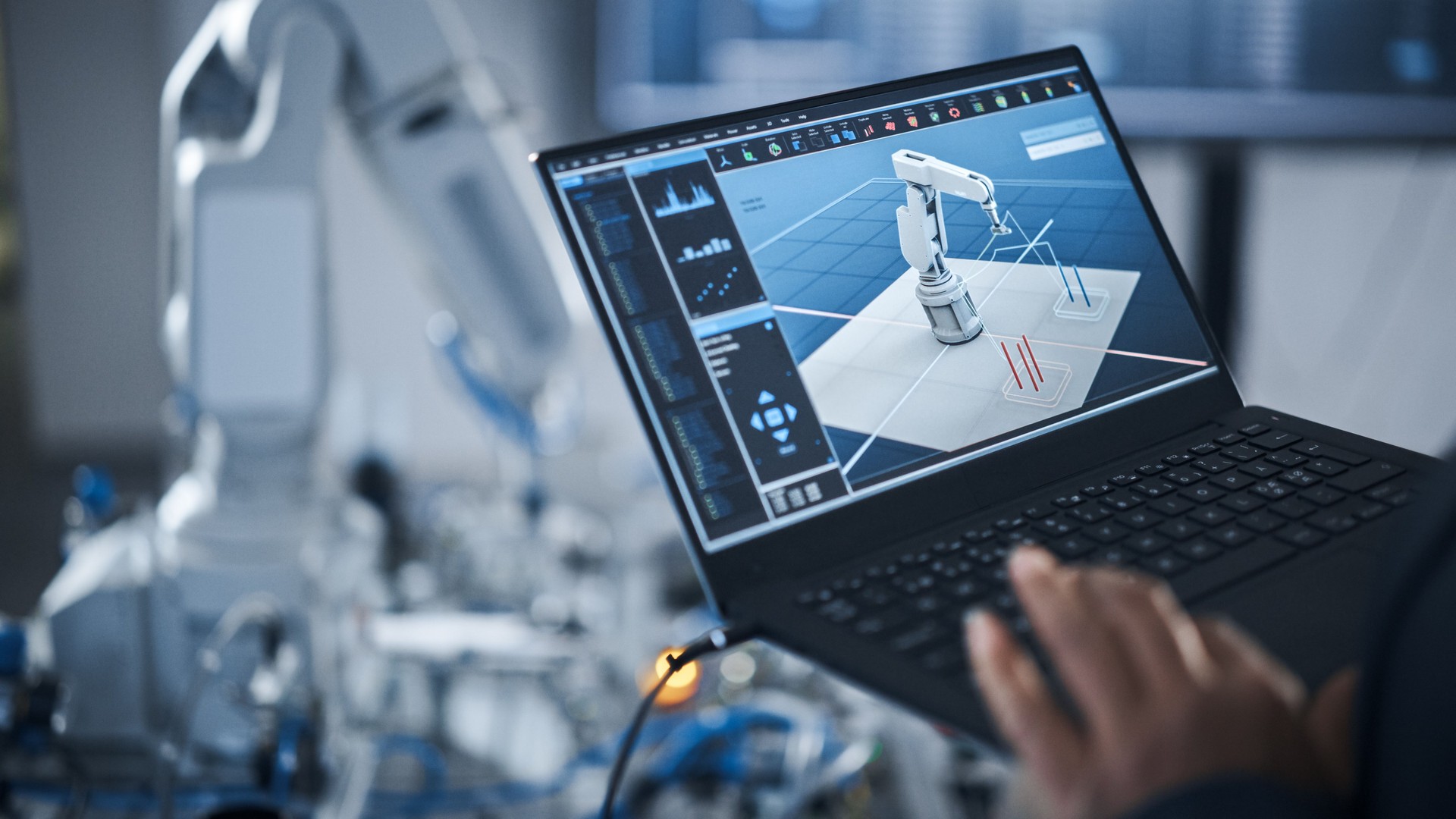 Black Female Engineer Using Laptop for Programming Robotic Arm At the Modern Assembling Factory. New Generation of Advanced Technology in Automatic Manufacturing Industry Concept.